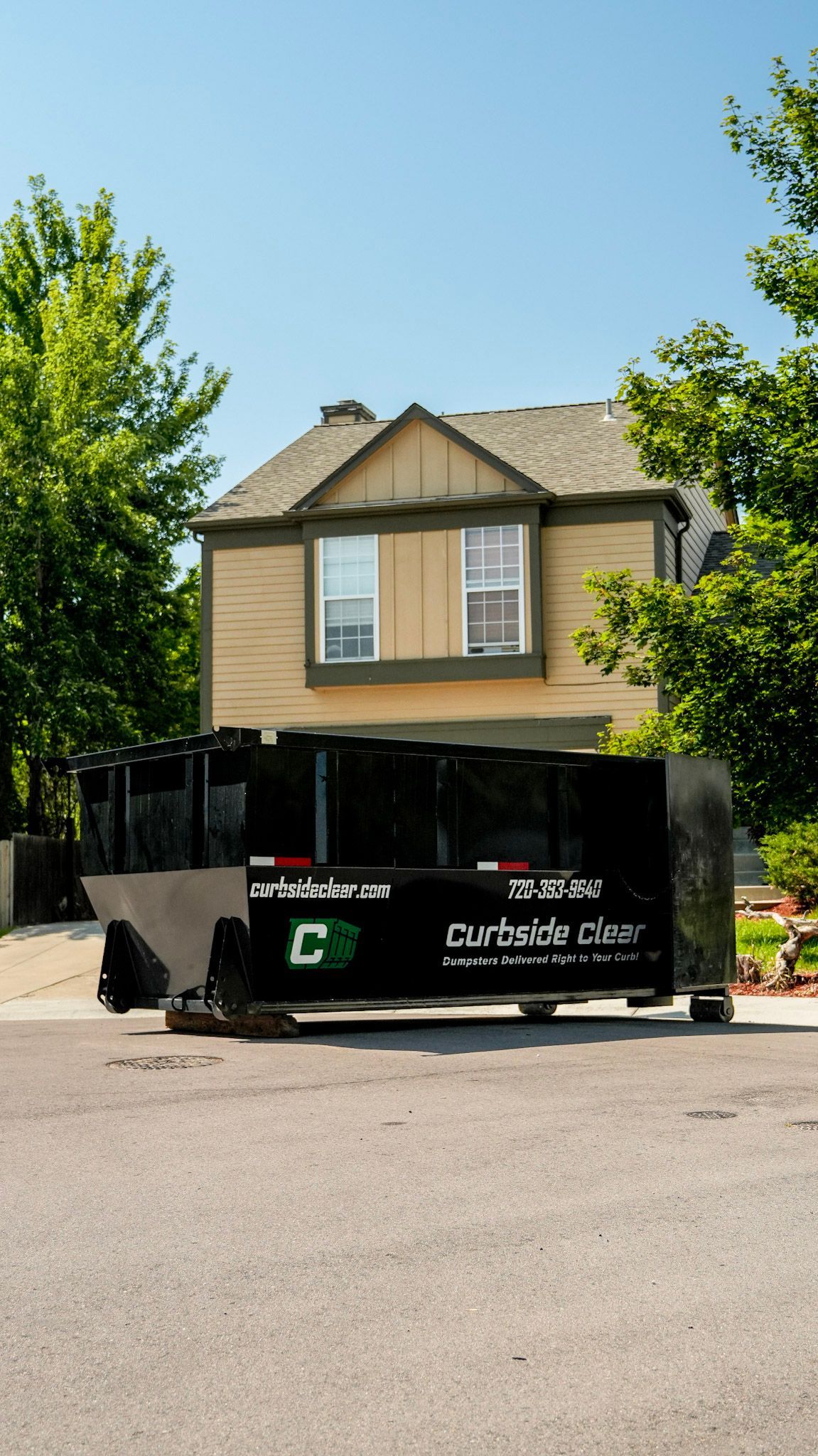 Curbside Clear dumpster rental on a street outside a home for renovation cleanup