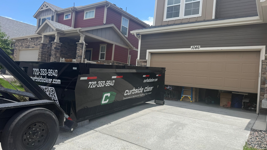 Curbside Clear dumpster delivered to Lakewood CO residential driveway for home cleanout
