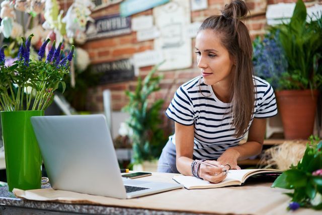 Young woman writing in a notebook — Thryv Foundation