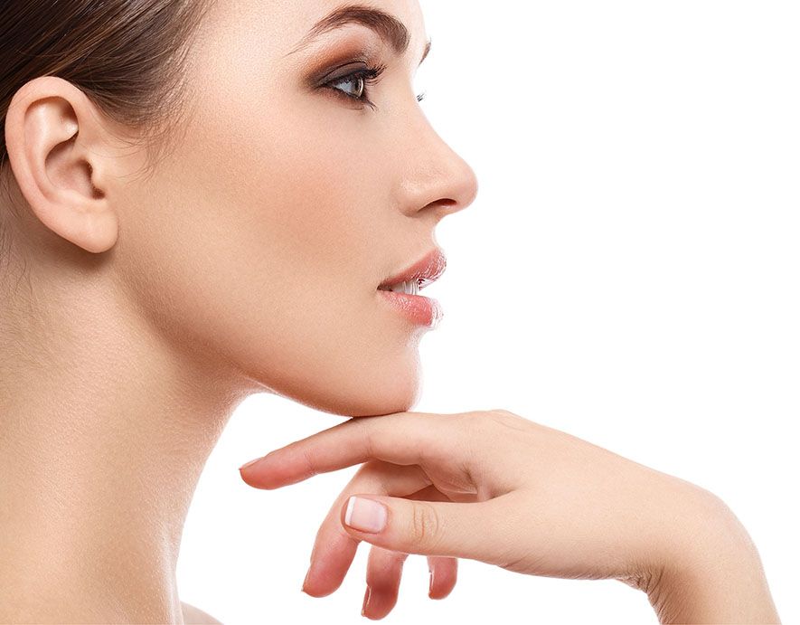 Side profile of a person touching their chin against a white background