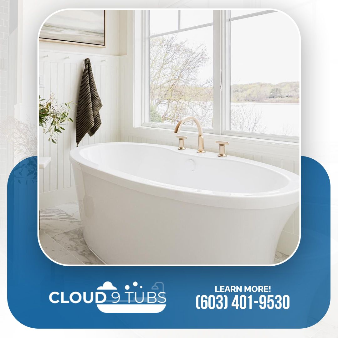 White freestanding bathtub in a bright bathroom by a window, with company logo and phone number (603) 401-9530.