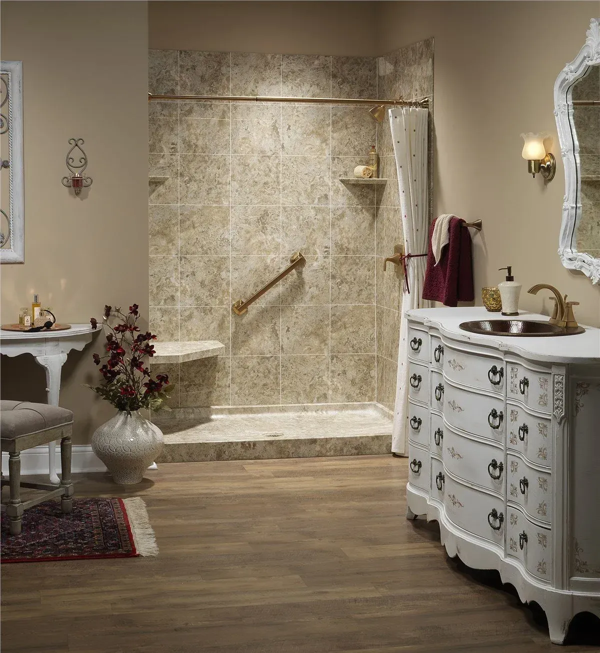 A vintage-style bathroom features a white vanity, a tiled walk-in shower with a gold grab bar, and elegant decor.