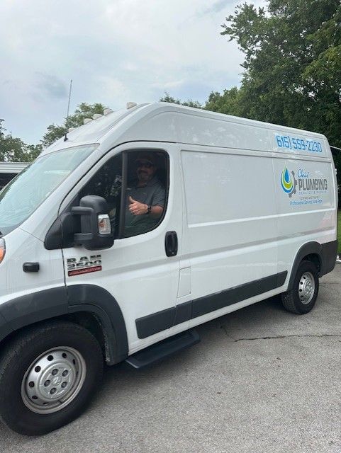 White service van with company logo parked outdoors, driver visible in the cab.