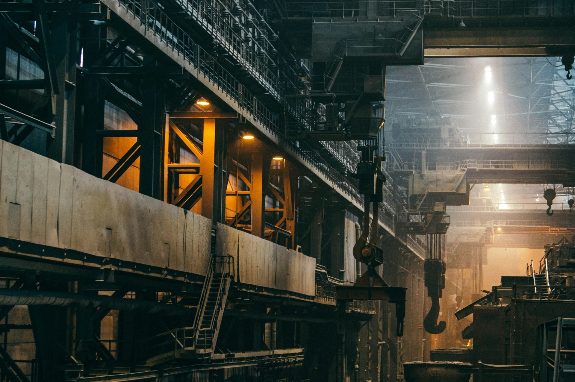 Industrial factory interior with equipment and warm lighting.