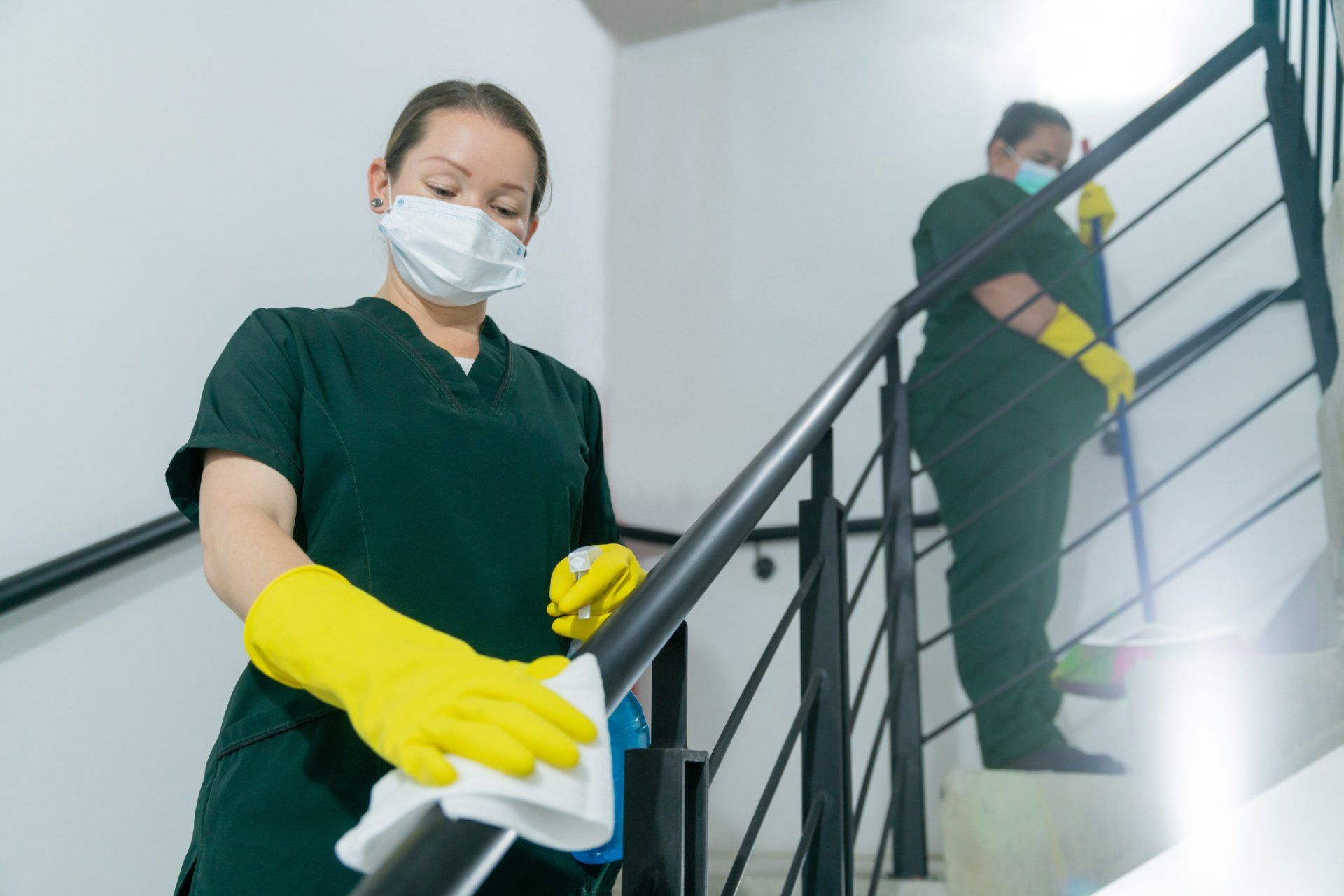 Woman Cleaning Rail — Medford, OR — Rogue Valley Maids