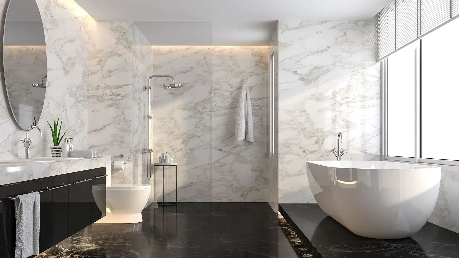 Luxurious bathroom with marble walls, black floor, soaking tub, toilet, and modern fixtures.
