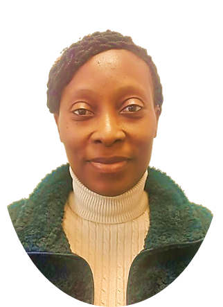 Woman with short hair wearing a white turtleneck and green jacket, smiling at the camera.