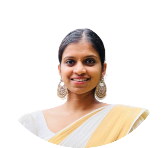 Woman smiling, wearing large earrings and a white and yellow shawl.