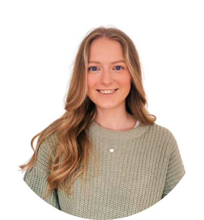 Woman with long blonde hair smiles, wearing a green sweater and silver necklace.