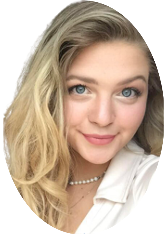 Blonde woman with blue eyes, smiling, wearing a pearl necklace and white shirt.
