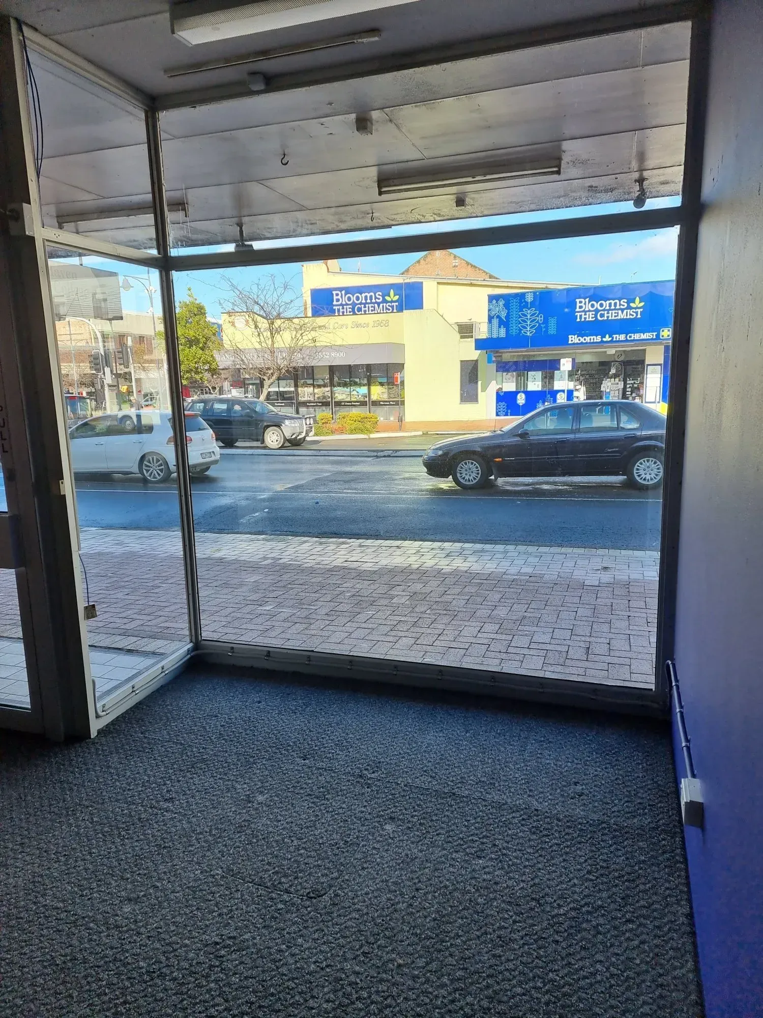 View From a Doorway Onto a Street With Cars and Businesses — Awesome Window Tint In Wauchope, NSW