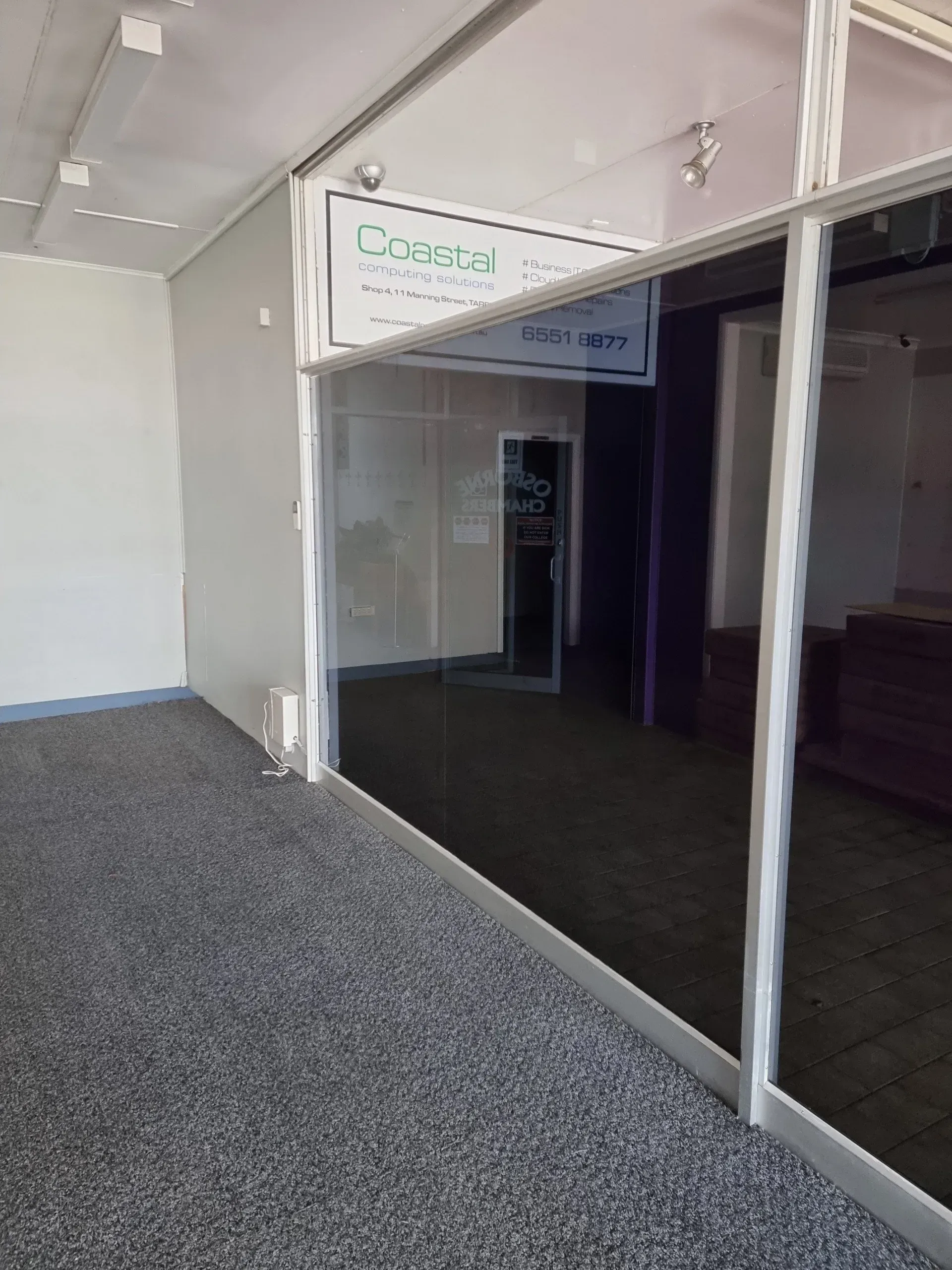 Retail Storefront Interior With Grey Carpet and a Glass Door — Awesome Window Tint In Wauchope, NSW