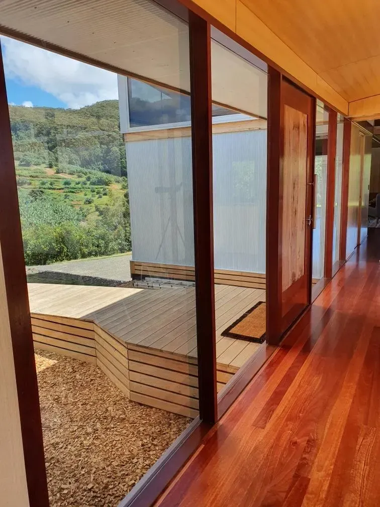 Modern wooden hallway with floor-to-ceiling windows — Awesome Window Tint In Kempsey, NSW