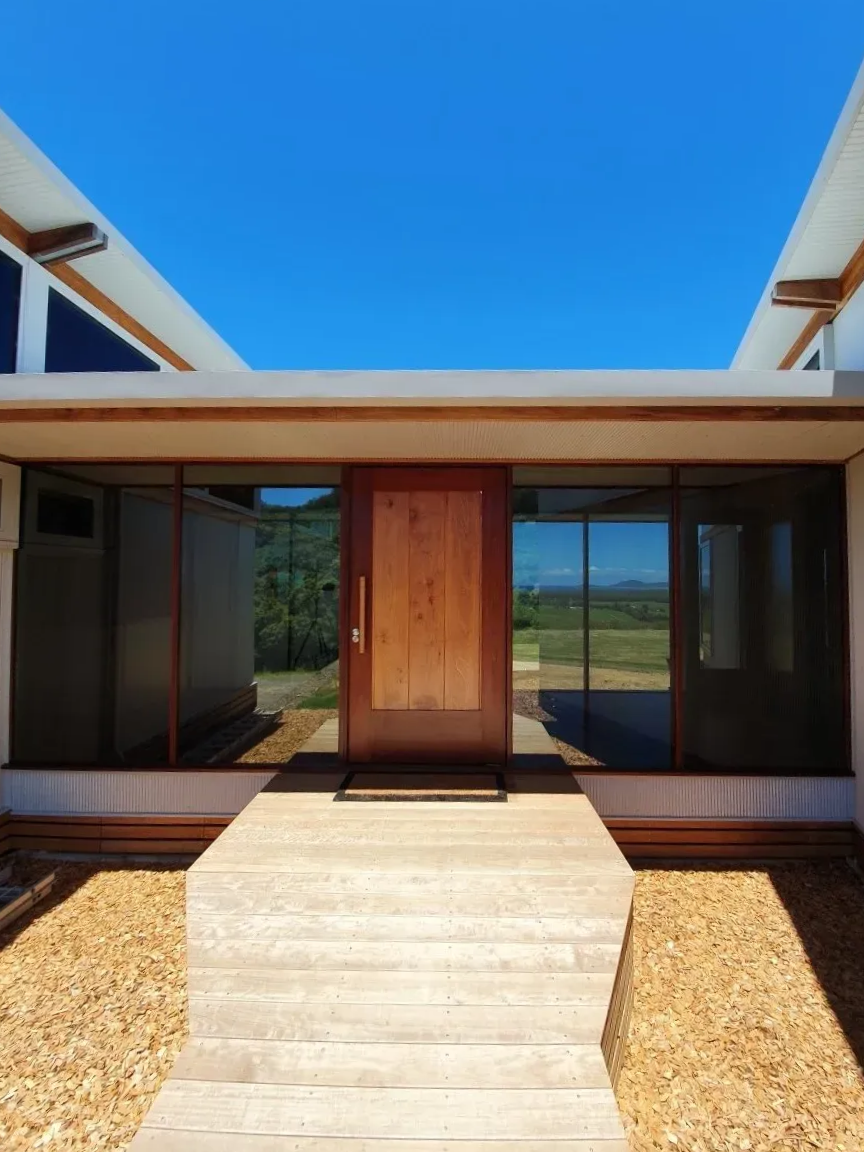 A Wooden Front Door Set in a Modern Building With Large Windows — Awesome Window Tint In Wauchope, NSW
