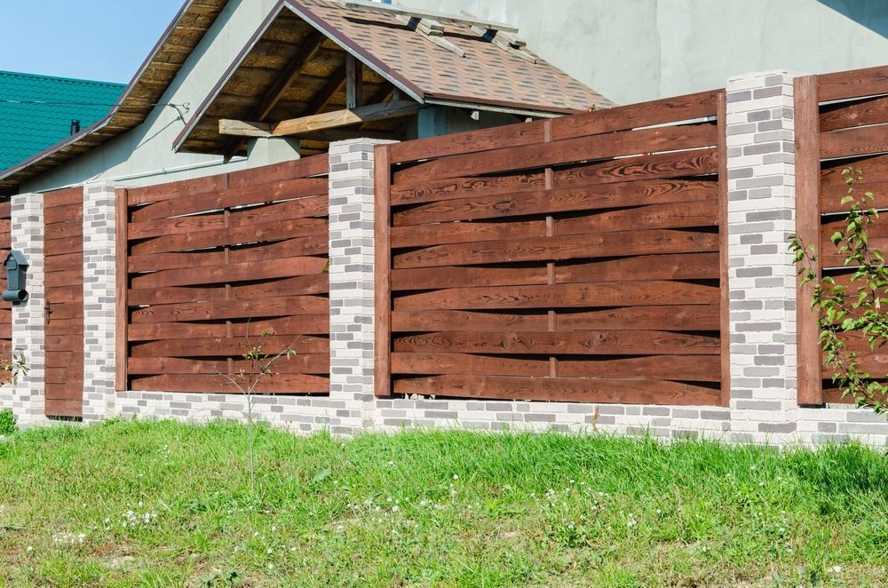 Wooden Fence With Woven Design and Brick Pillars in Front of a House — Fencer Steve In Wauchope, NSW