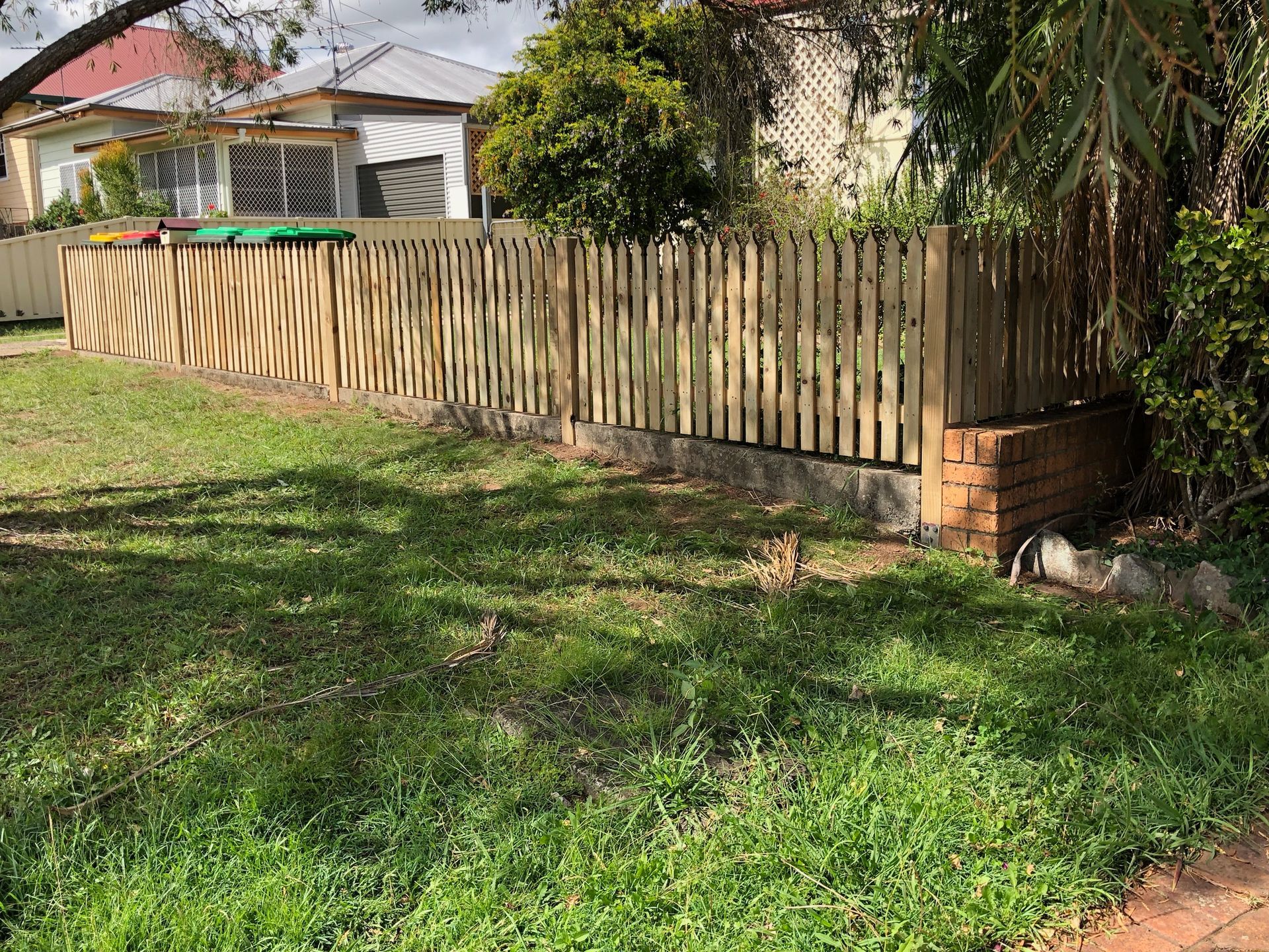 Wooden Fence in Front of a House With Green Grass and a Brick Structure — Fencer Steve In Temagog, NSW