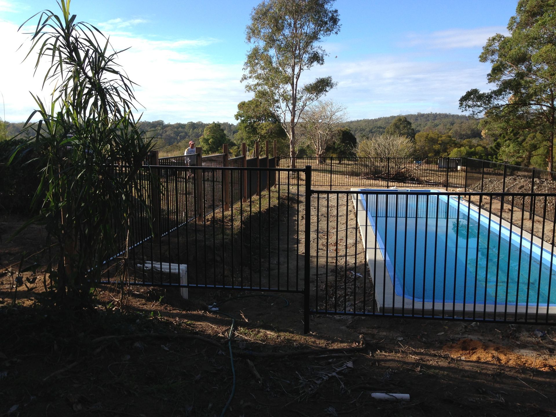 Black Fenced Pool With Blue Water, Surrounded by Trees and Open Fields — Fencer Steve In Hat Head, NSW