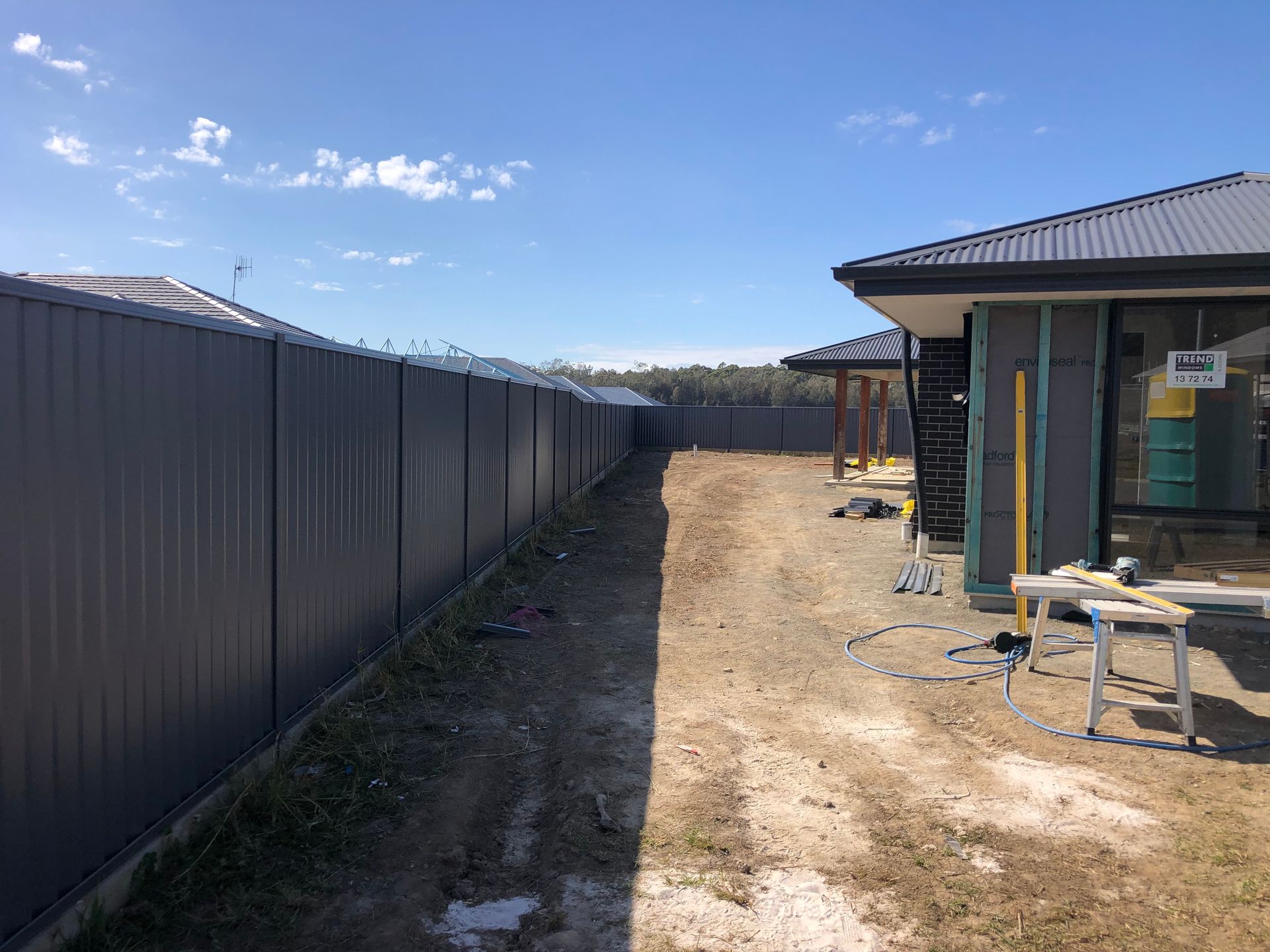 Gray Metal Fence Along a Dirt Yard — Fencer Steve In Temagog, NSW