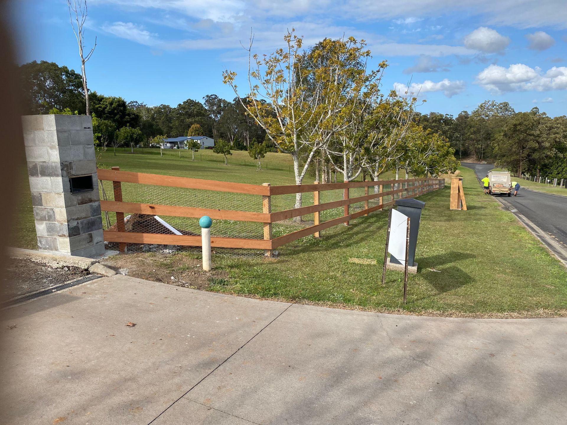 A Brown Wooden Fence Borders a Grassy Lawn Next to a Driveway — Fencer Steve In Temagog, NSW