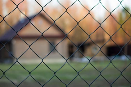 Chain-link Fence in the Foreground; a Blurred House — Fencer Steve In Kempsey, NSW