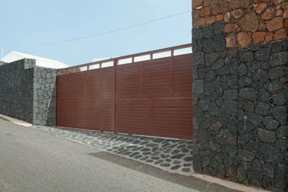 Brown Metal Gate Between Stone Walls on a Paved Road — Fencer Steve In South West Rocks, NSW