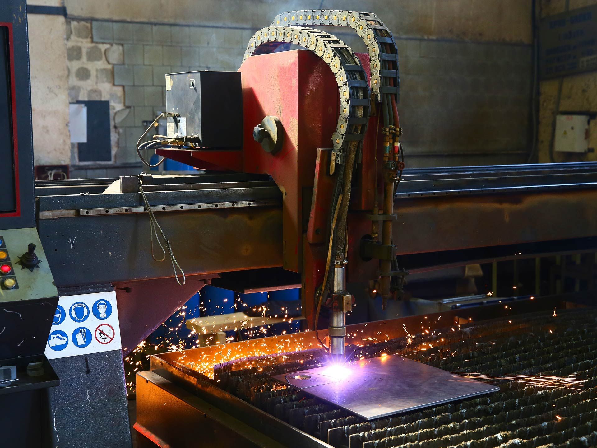 An industrial CNC plasma cutting of a metal plate.