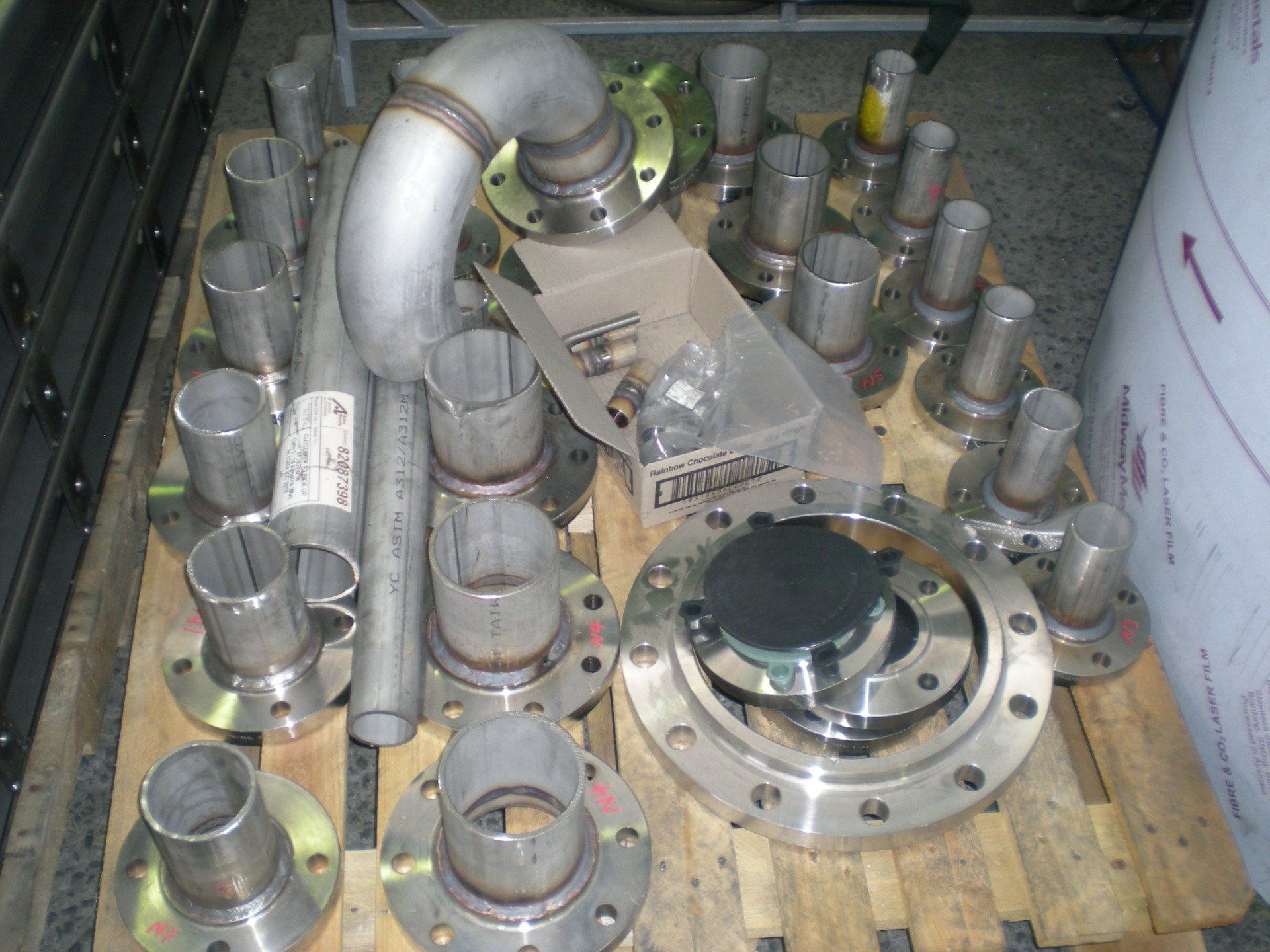 Components include elbows, straight pipes, and flanged connectors; some hardware is visible.