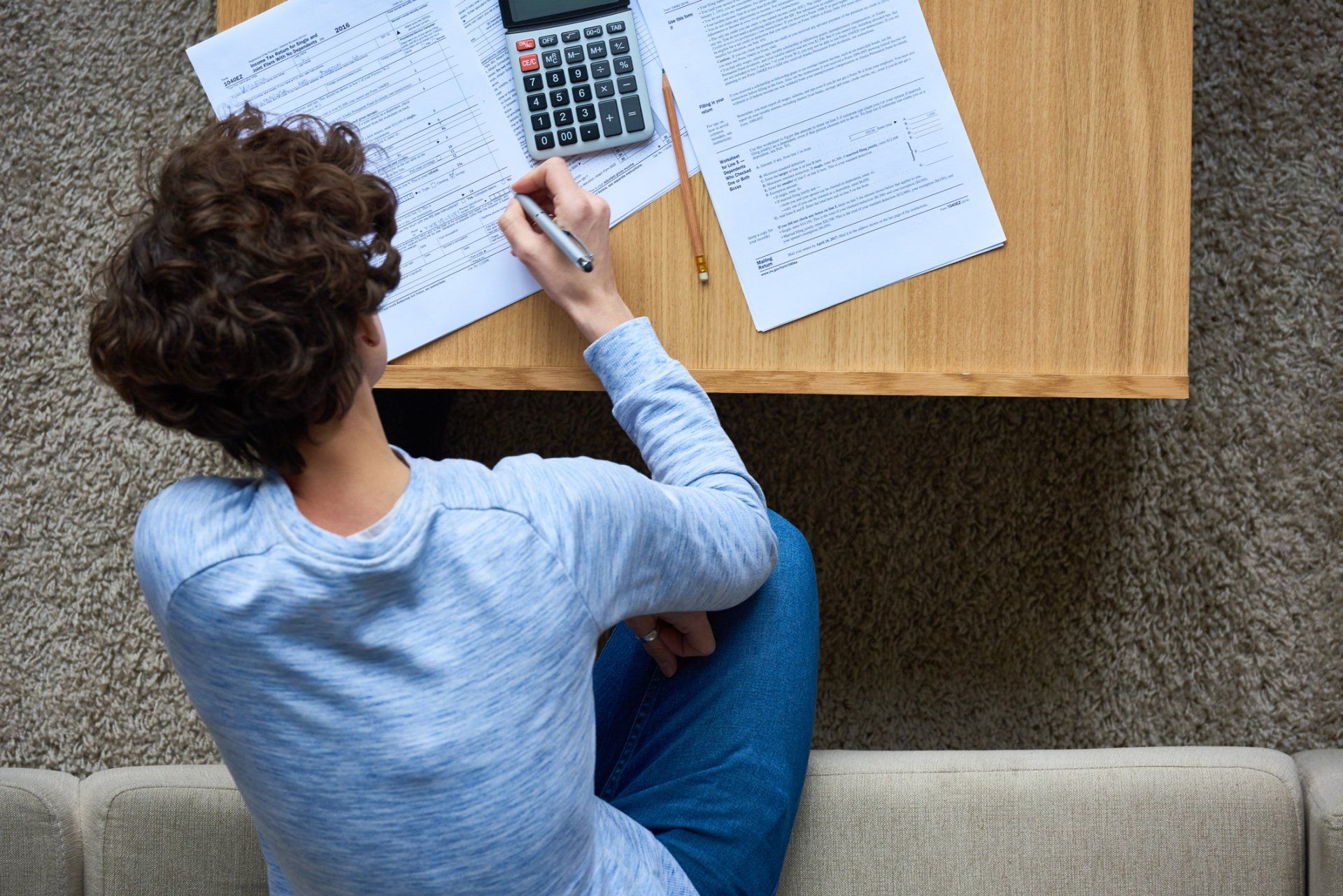 Woman Working with Tax Forms — Helensvale QLD — Fay & Redman