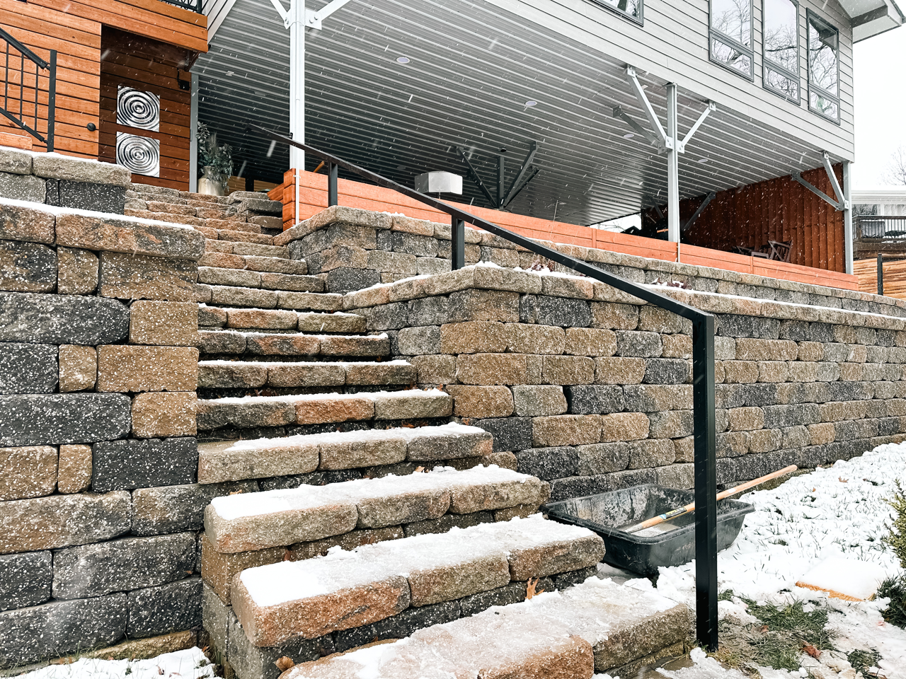 A Snowy Staircase With a Railing Fabricated By Merit Welding in Central Missouri. Call Today!