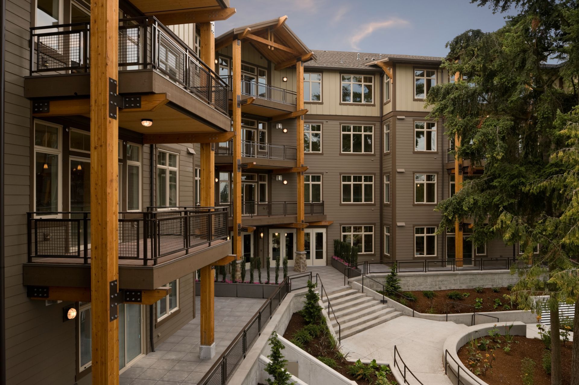 Modern apartment courtyard with balconies, brick buildings, and landscaped walkways