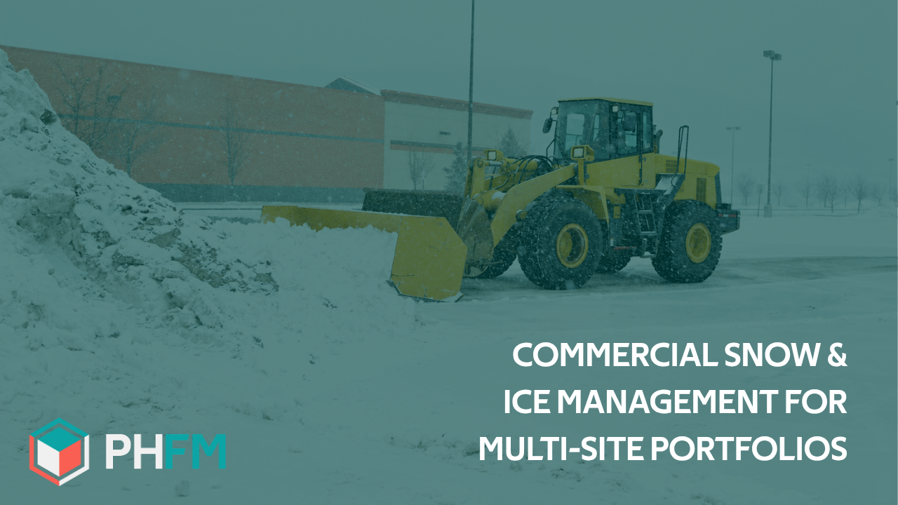 Commercial snow loader clearing a snow-covered parking lot at a multi-site commercial property