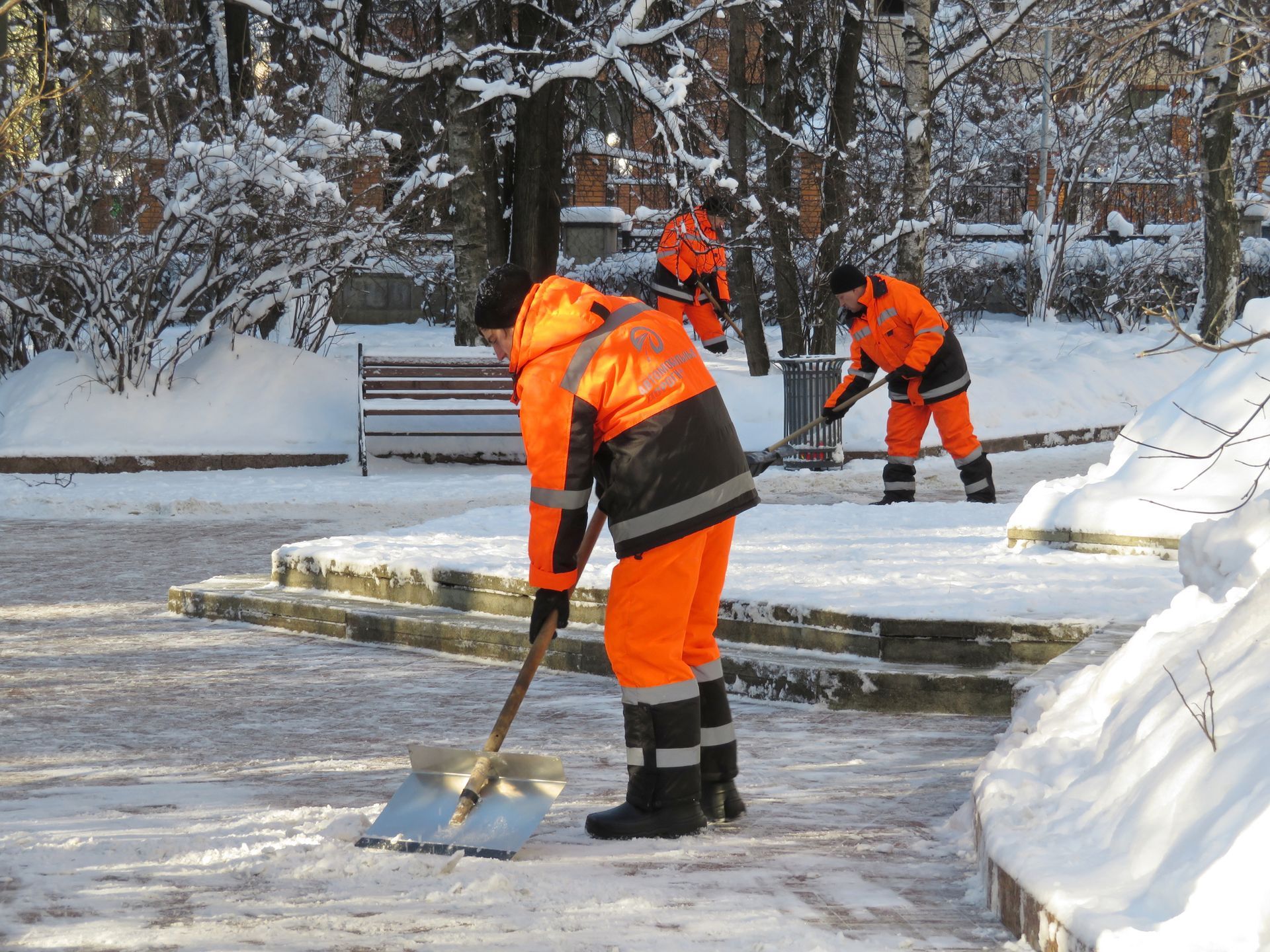 PHFM Contractors shoveling snow in a parking lot