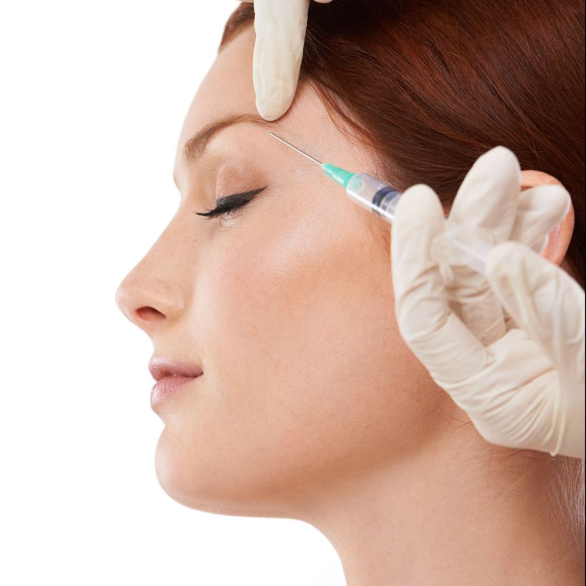 Woman receiving injection in her forehead; gloved hands, syringe.
