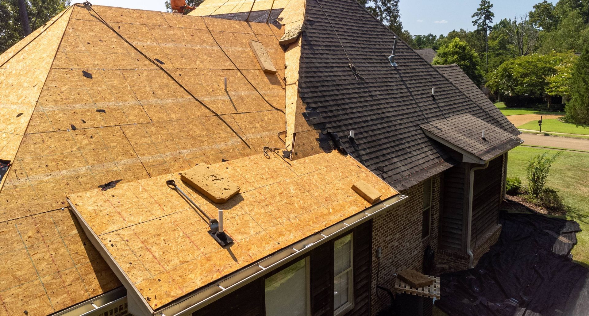A home with a new roof in the middle of proper installation