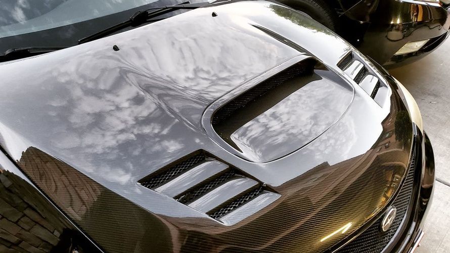 A close up of the hood of a black car.