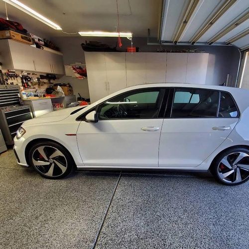 A white car is parked in a garage.