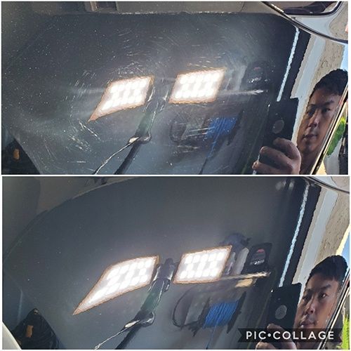 A man is taking a picture of himself in the mirror of a car.