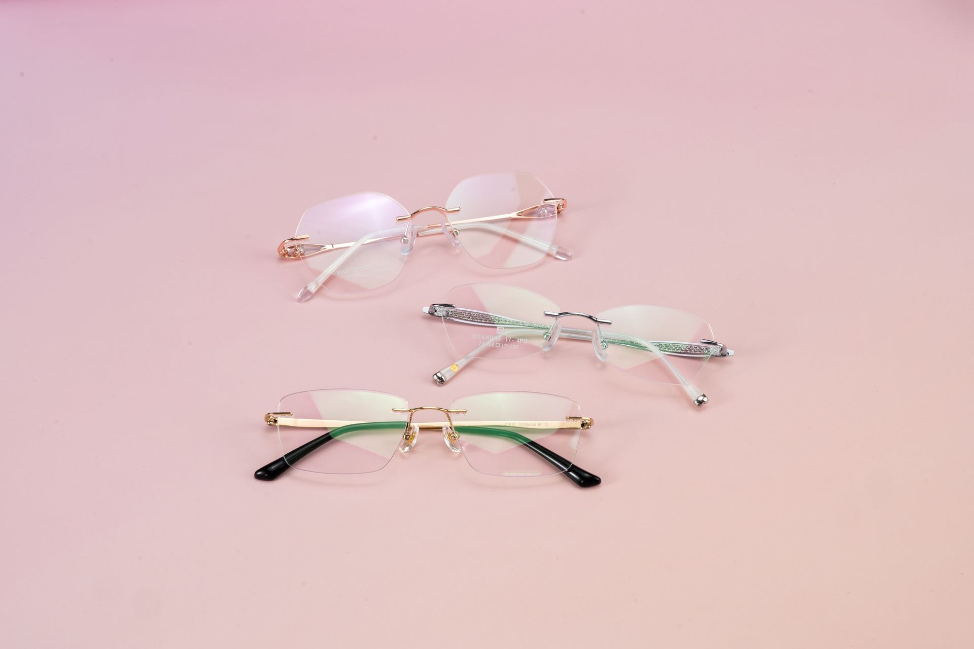 Lightweight rimless titanium eyeglasses resting on a clean light surface