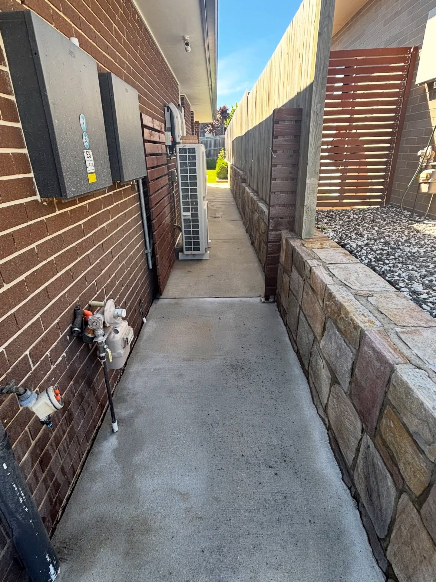 Narrow Concrete Walkway Between a Brick Wall — Pressure Perfect Cleaning Solutions in Symonston, ACT