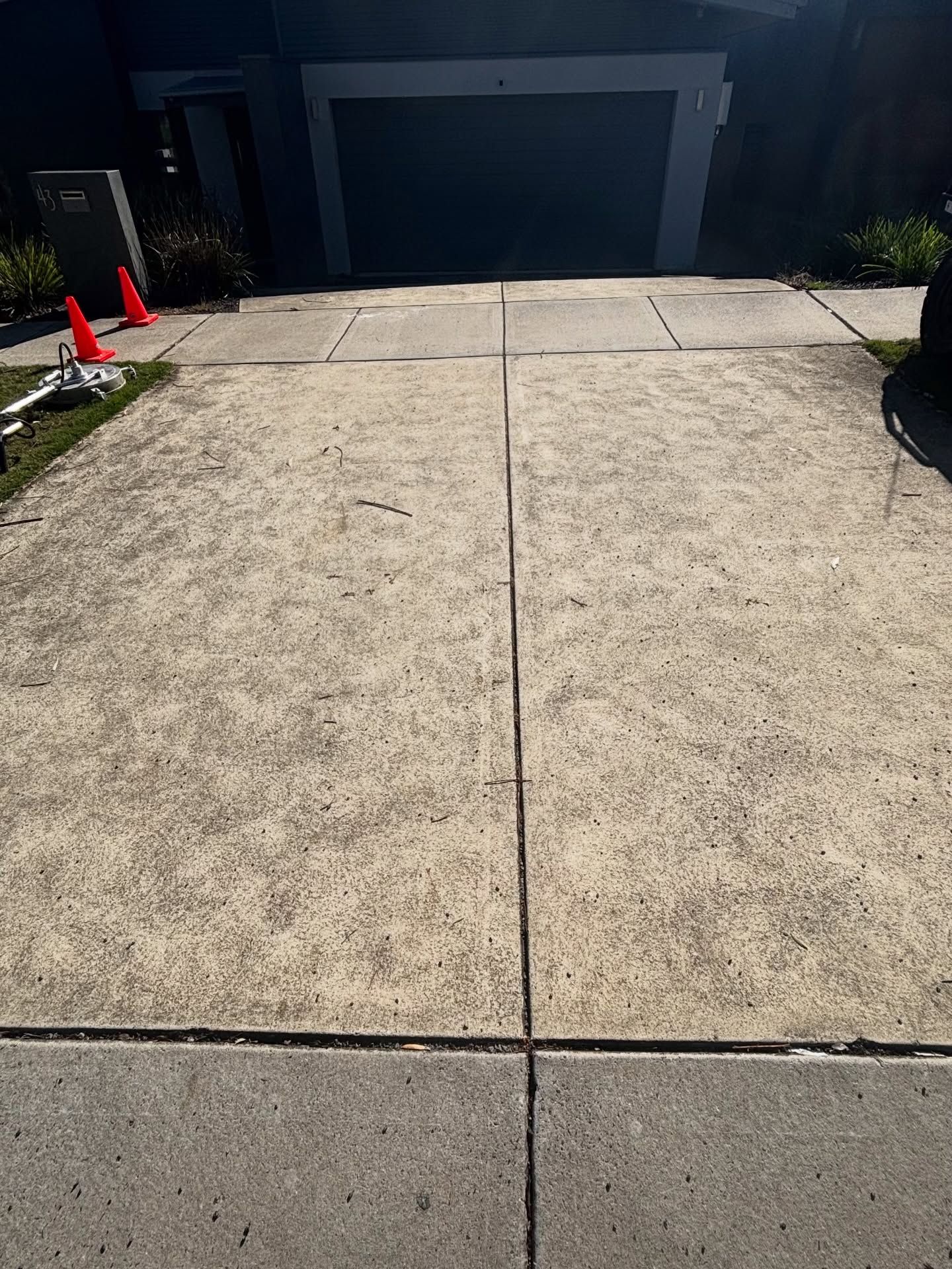 Concrete Driveway Leading to a Garage Entrance — Pressure Perfect Cleaning Solutions in Symonston, ACT