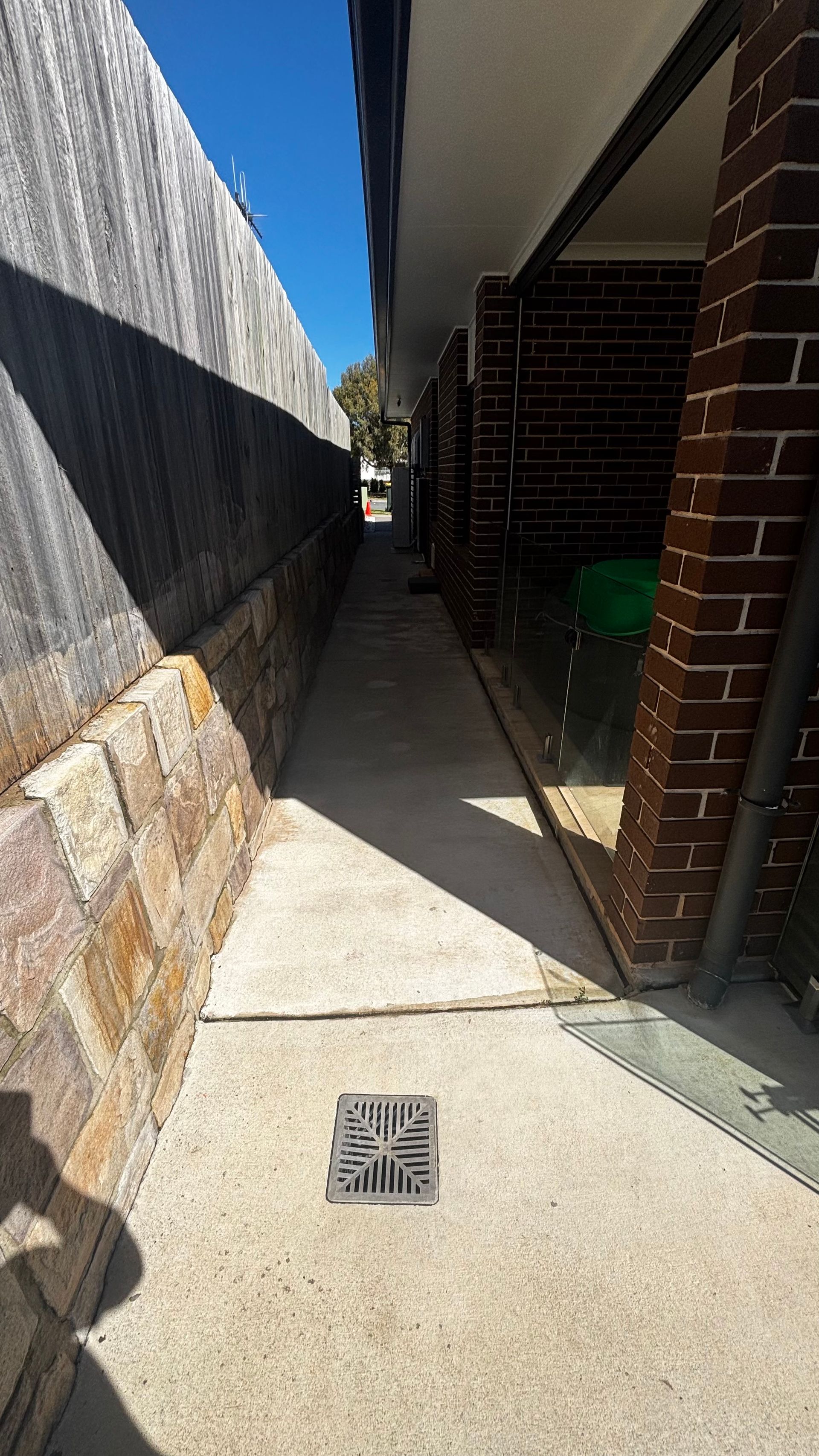 Narrow Outdoor Concrete Walkway Between a Stone — Pressure Perfect Cleaning Solutions in Bungendore, NSW