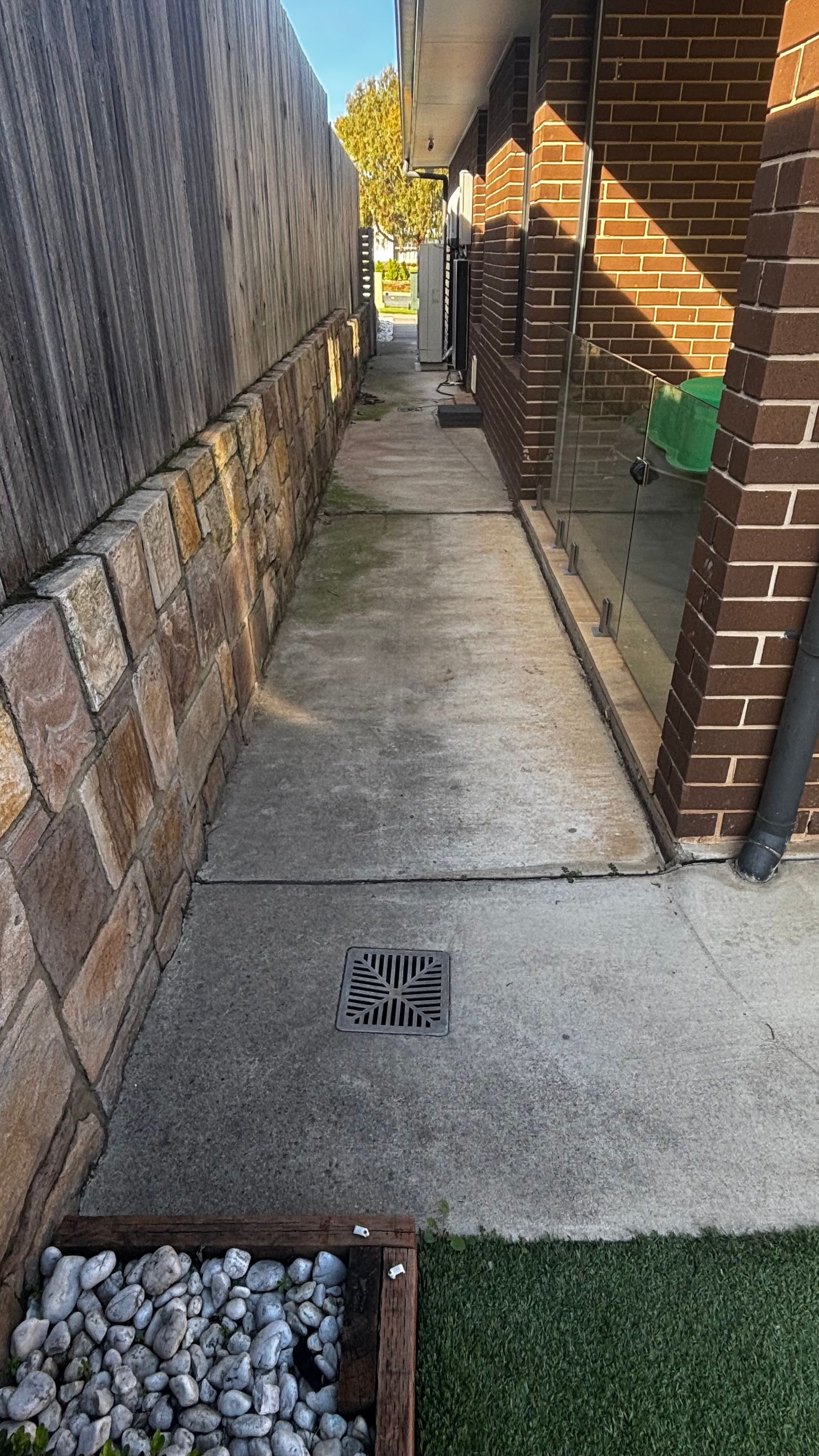 Concrete Walkway Runs Between a Stone Retaining Wall — Pressure Perfect Cleaning Solutions in Queanbeyan, NSW