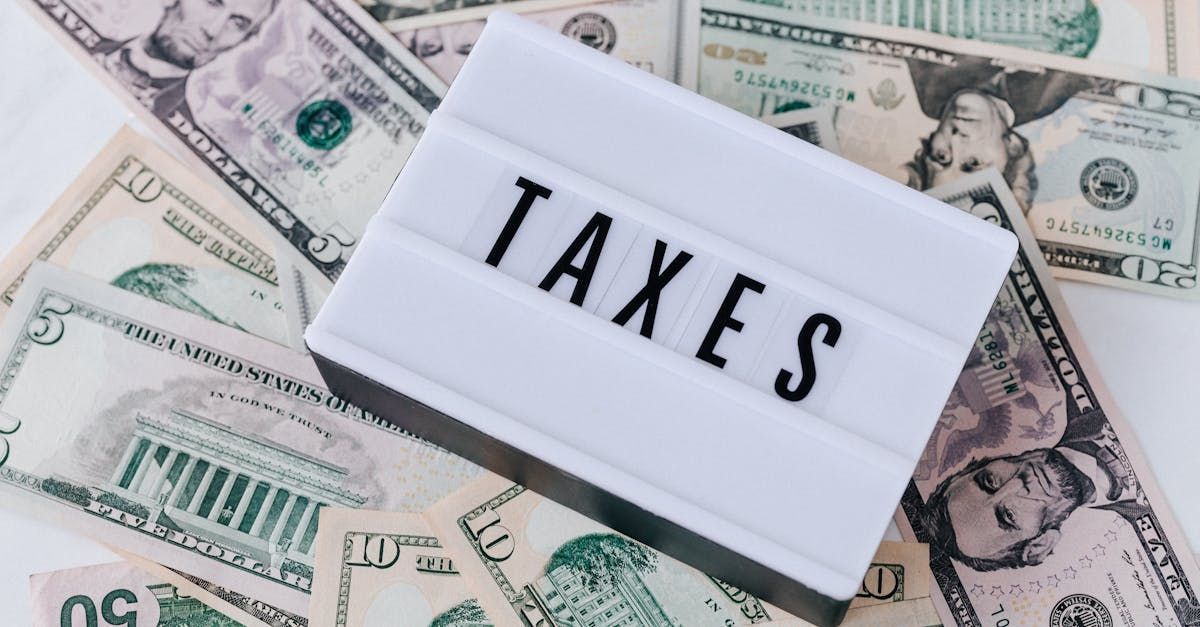 A sign that says `` taxes '' is sitting on top of a pile of money.