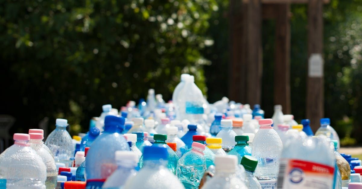 A pile of plastic bottles sitting on top of each other on a table.