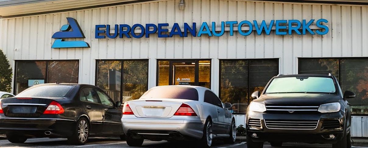 European AutoWerks storefront with parked cars in front, including black, silver, and dark SUV. | European Autowerks – Virginia Beach