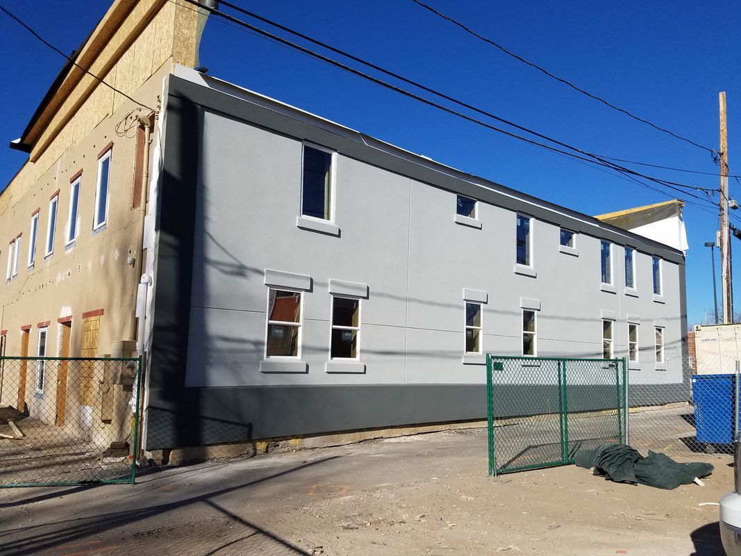 A building with a lot of windows and a fence around it