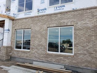 A brick building with a lot of windows is being built.