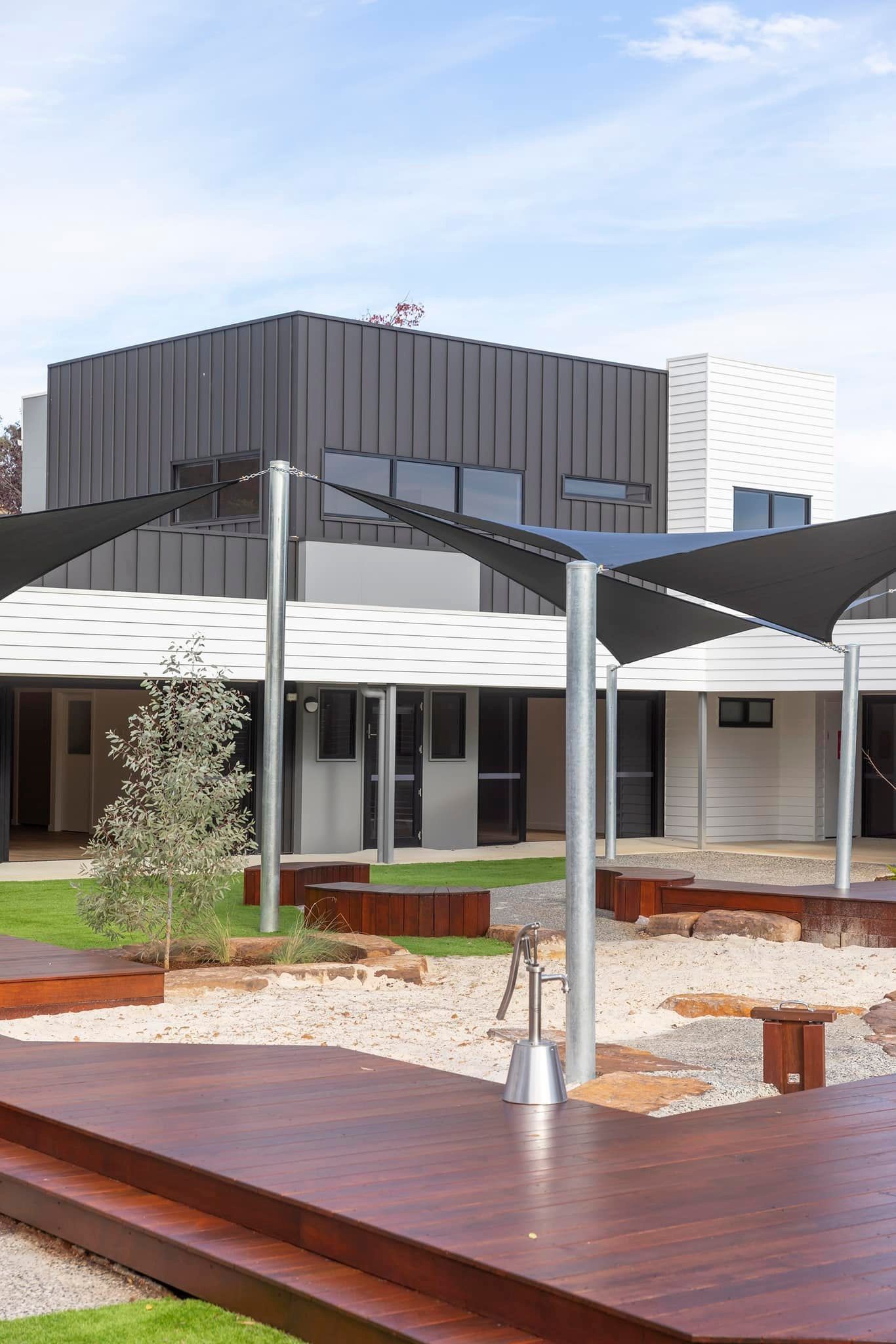 A Modern Building With Metal Siding and a Courtyard — RYDALL BUILDING AND DEVELOPMENT in Freshwater, QLD