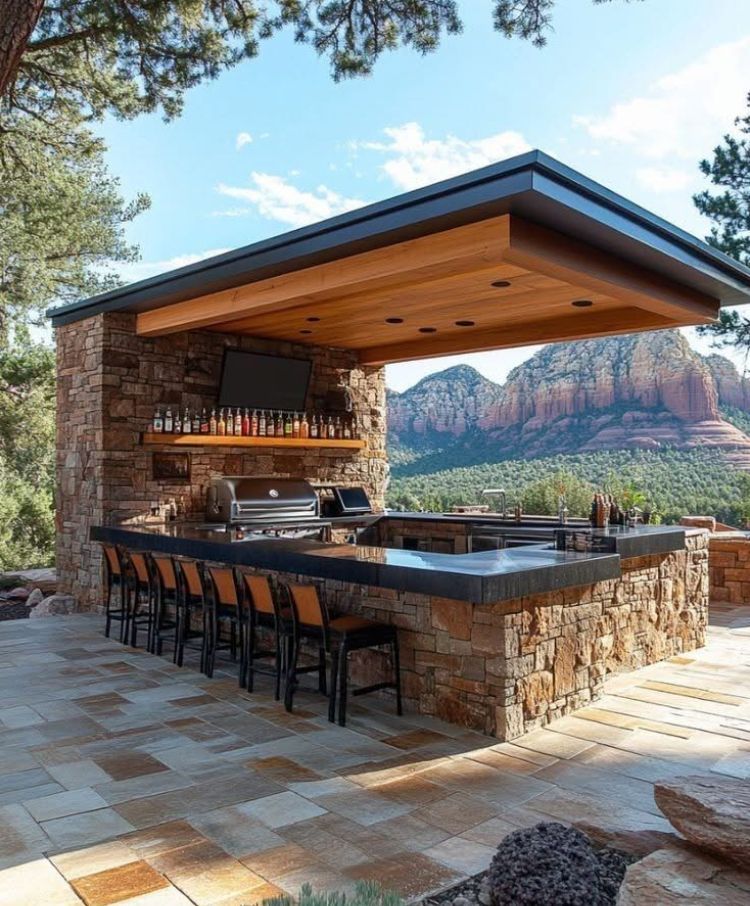 Outdoor Stone Kitchen With Bar Seating and Red Rock Mountain View — RYDALL BUILDING AND DEVELOPMENT in Freshwater, QLD
