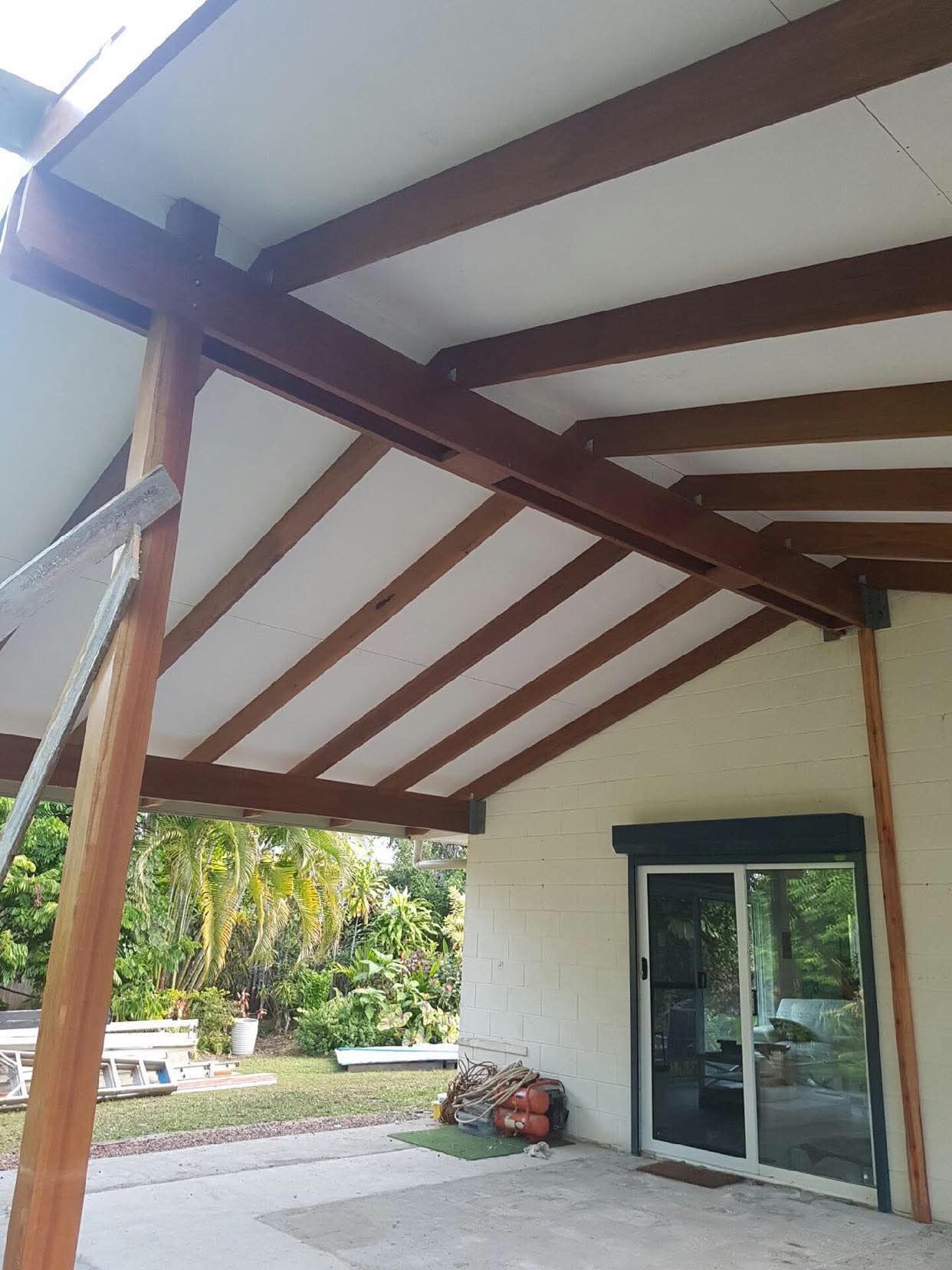 Covered Patio With Wooden Beams, White Ceiling, and Sliding Glass Door — RYDALL BUILDING AND DEVELOPMENT in Freshwater, QLD